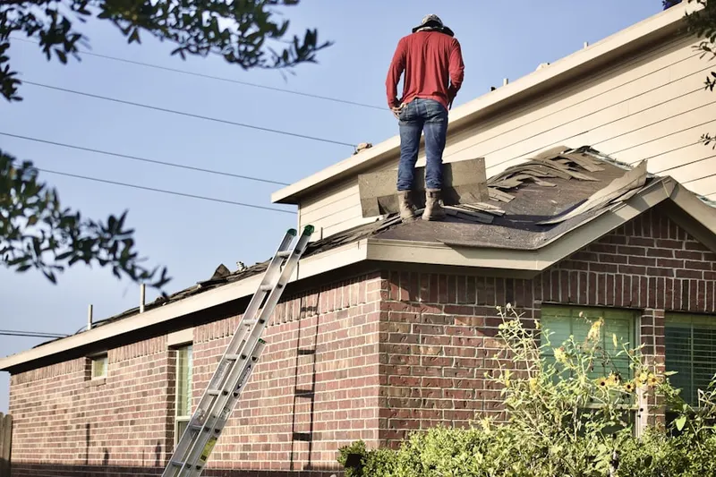 Professional roofer working on a residential roof in East Del Paso Heights
